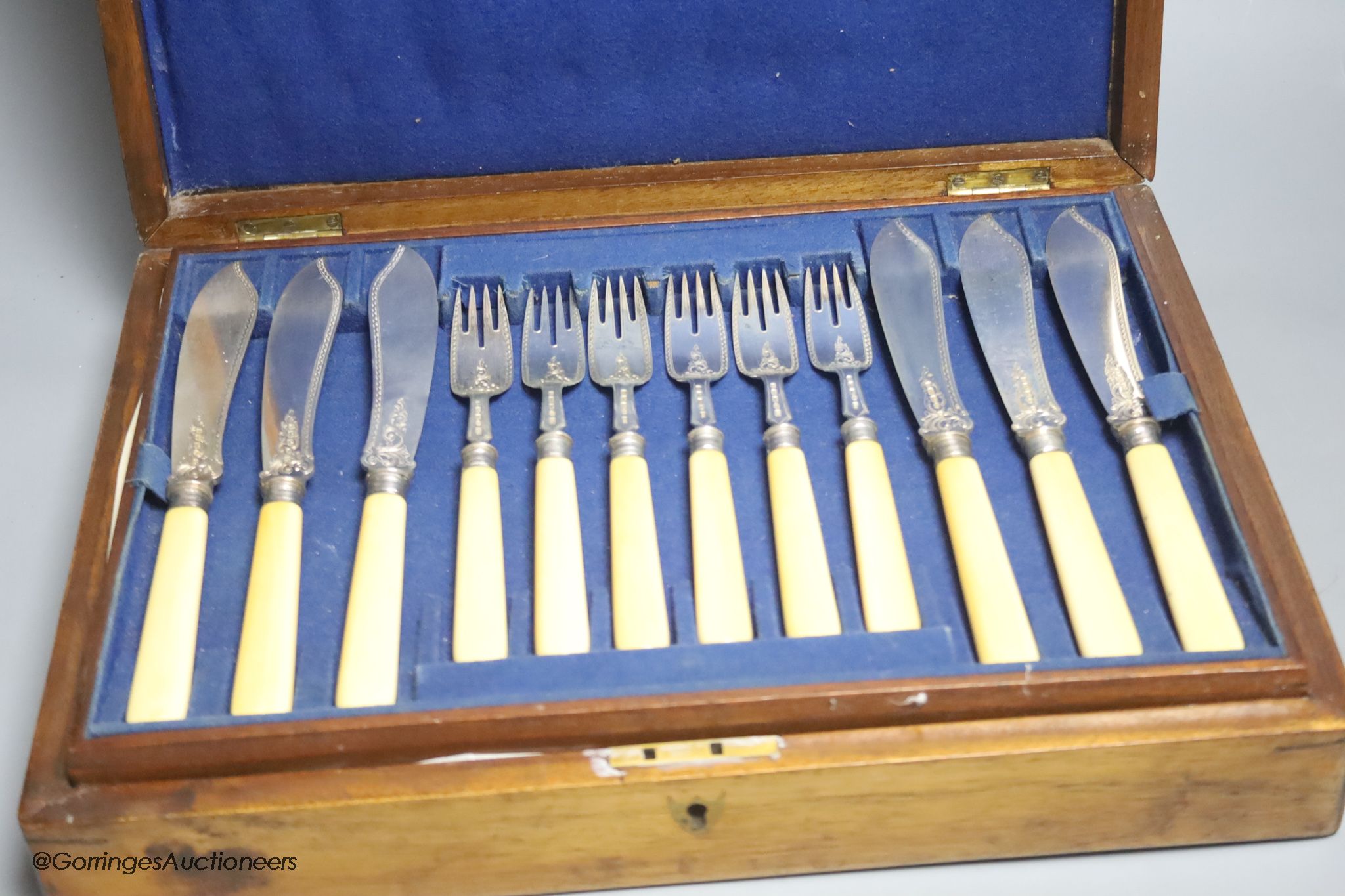 A Victorian cased set of eighteen pairs of ivory handled engraved silver fish eaters by John Gilbert & Co, Birmingham, 1874/5